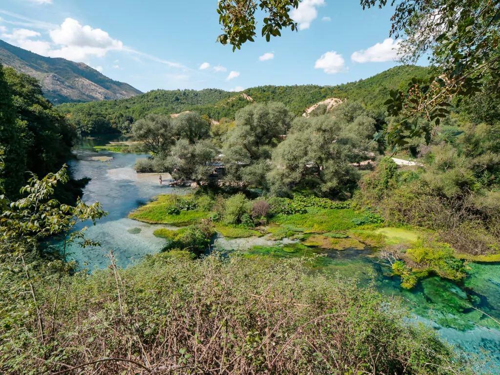 The Blue Eye natural spring in southern Albania displays its striking turquoise waters amidst lush green landscape