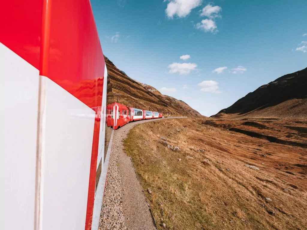 View out the Glacier Express window with alpine scenery
