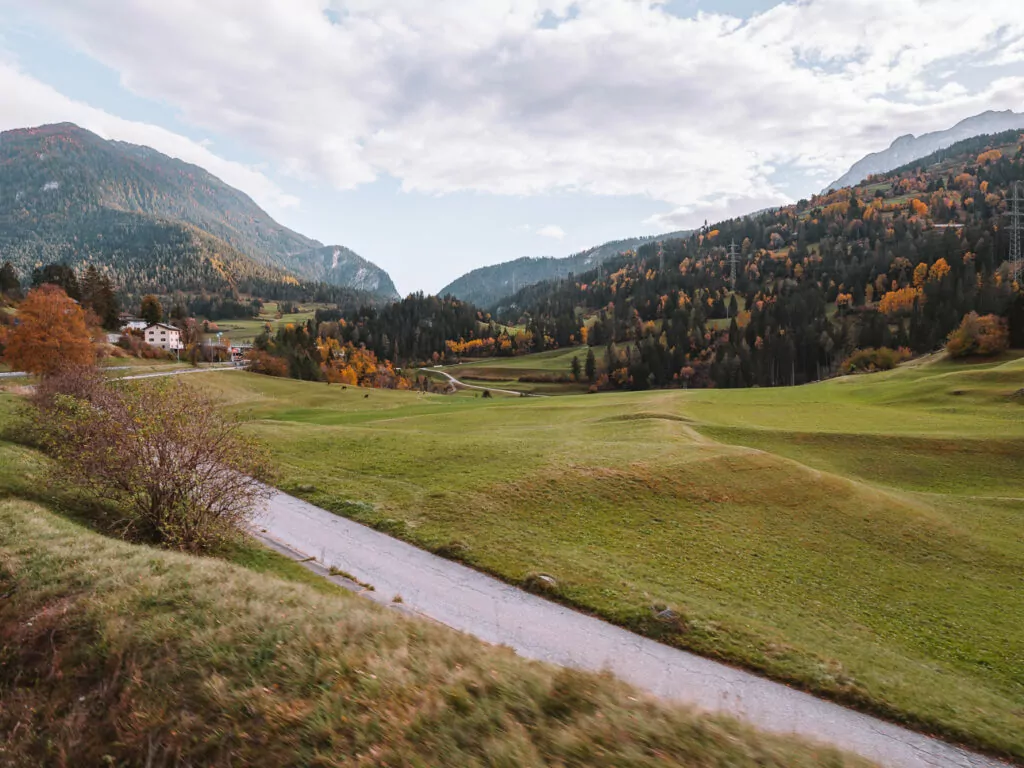 Lush green Swiss valley seen through the Glacier Express window