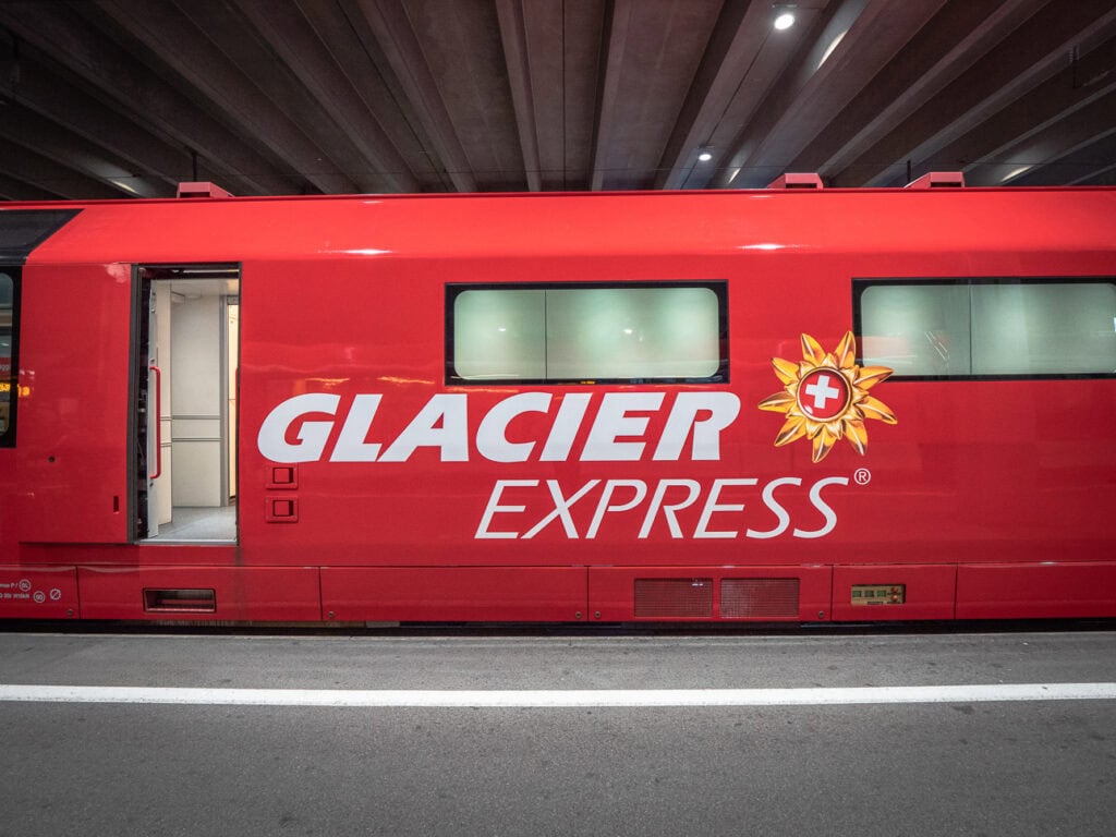 Red Glacier Express train carriage at a Swiss station