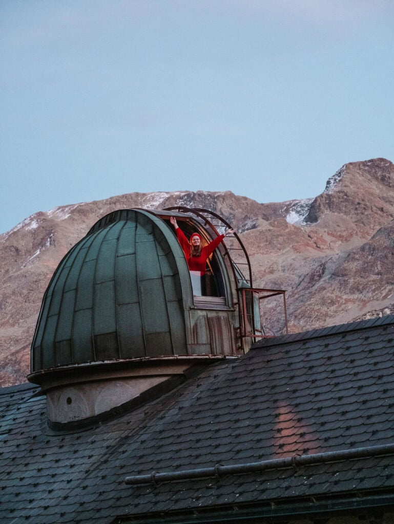 Observatory dome at Randolins hotel with snow-capped Swiss Alps in the background