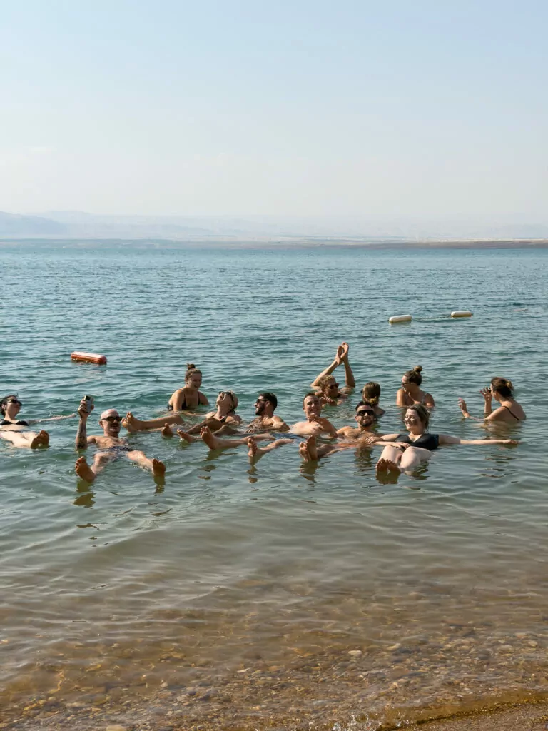 Group of travellers floating together in the Dead Sea in Jordan
