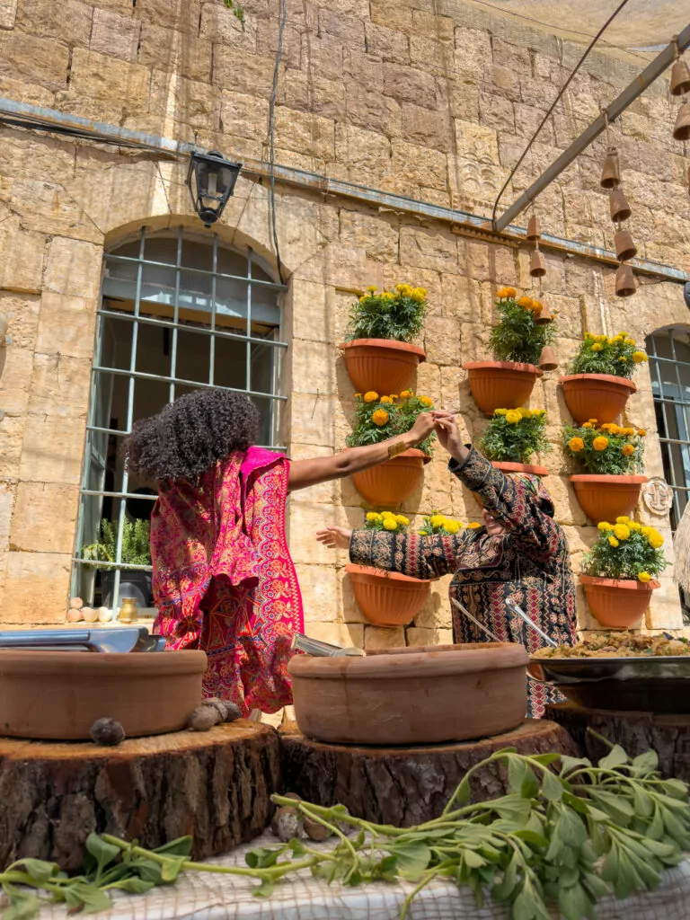 Courtyard of Beit Khayrat Souf, a Planeterra-supported community restaurant in Jordan, decorated with potted plants and local textiles