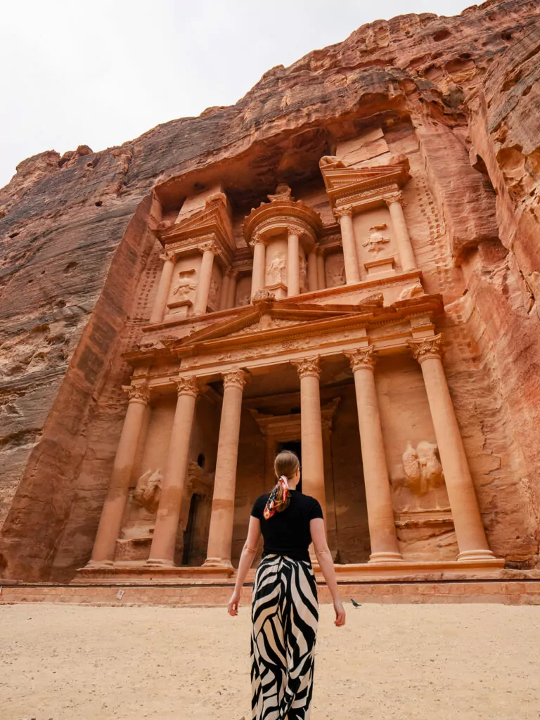 Woman standing in front of the Treasury at Petra, Jordan, one of the most iconic stops on a G Adventures Jordan tour