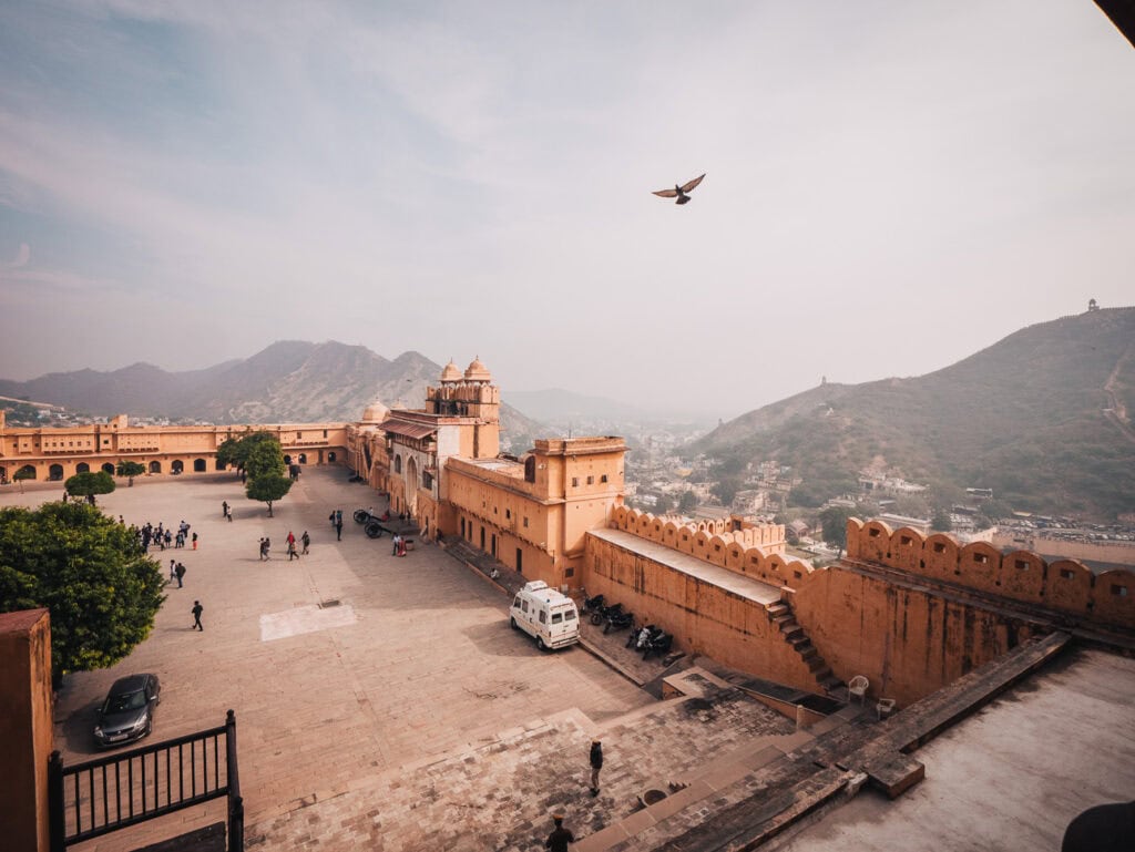 Amber Fort in Jaipur with expansive sandstone walls and courtyards overlooking the surrounding hills