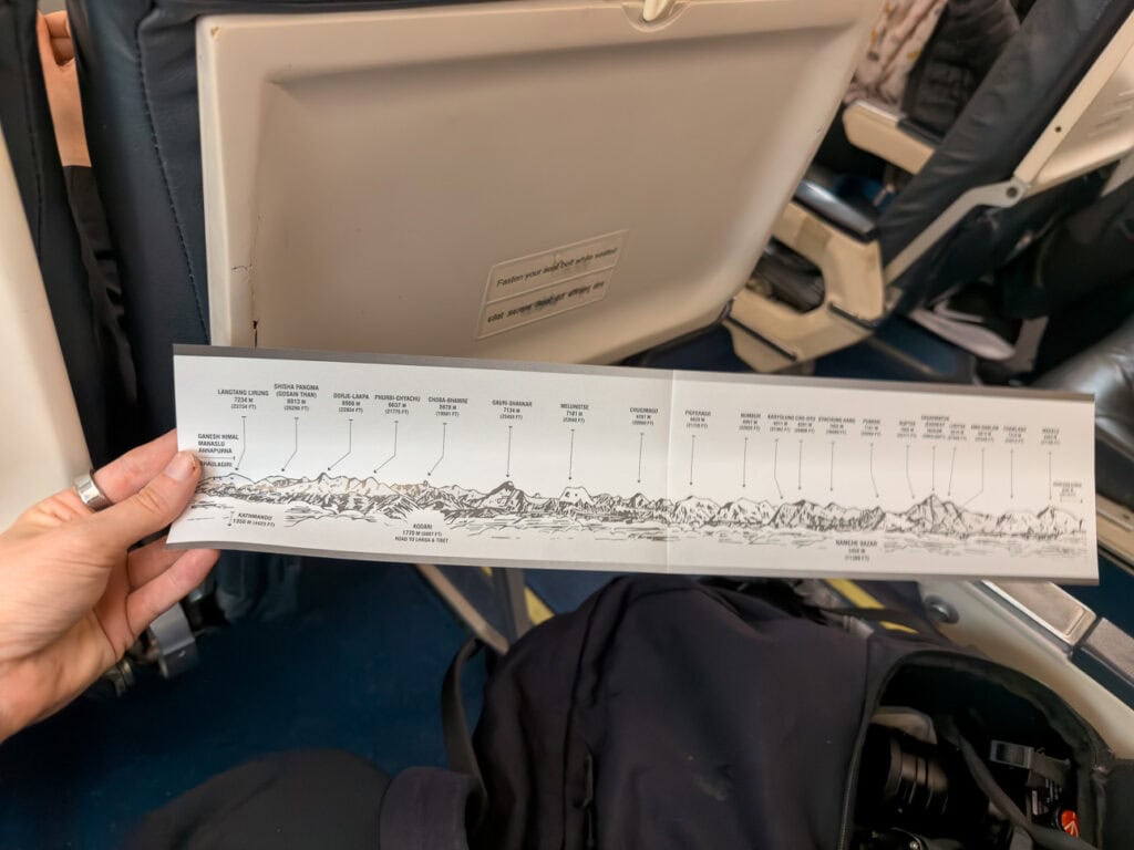 Laminated map of the Himalayan peaks held up inside the cabin during a scenic Everest flight