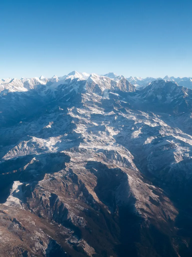 Hazy panorama of the Himalayan mountain range from a scenic flight over Nepal