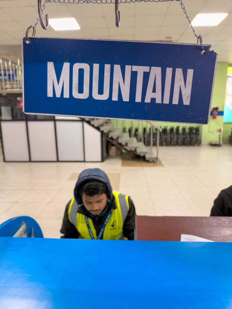 Check-in desk with a Mountain sign at the airport for the scenic Everest flight