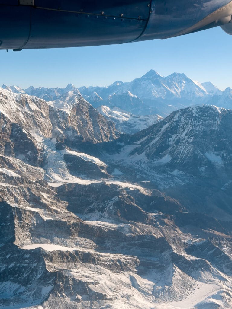Dramatic view of a towering Himalayan peak from the window of a scenic Everest flight
