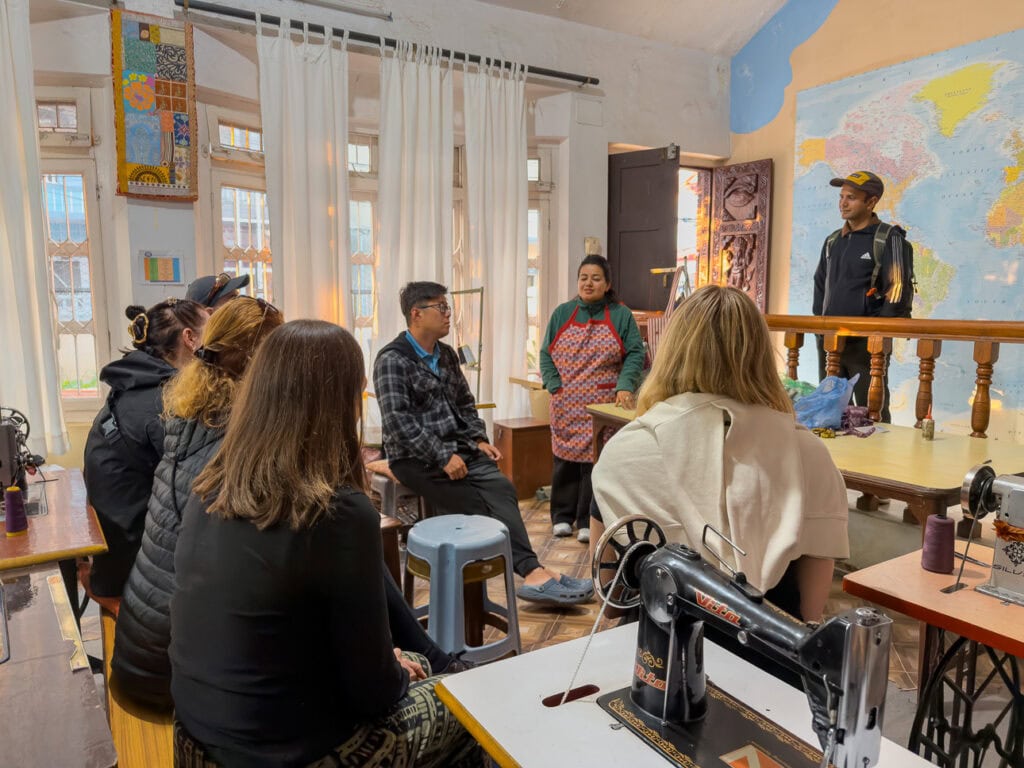 Travellers visiting the sewing room at Sungabha Seven Sisters on the One Life Adventures Nepal tour