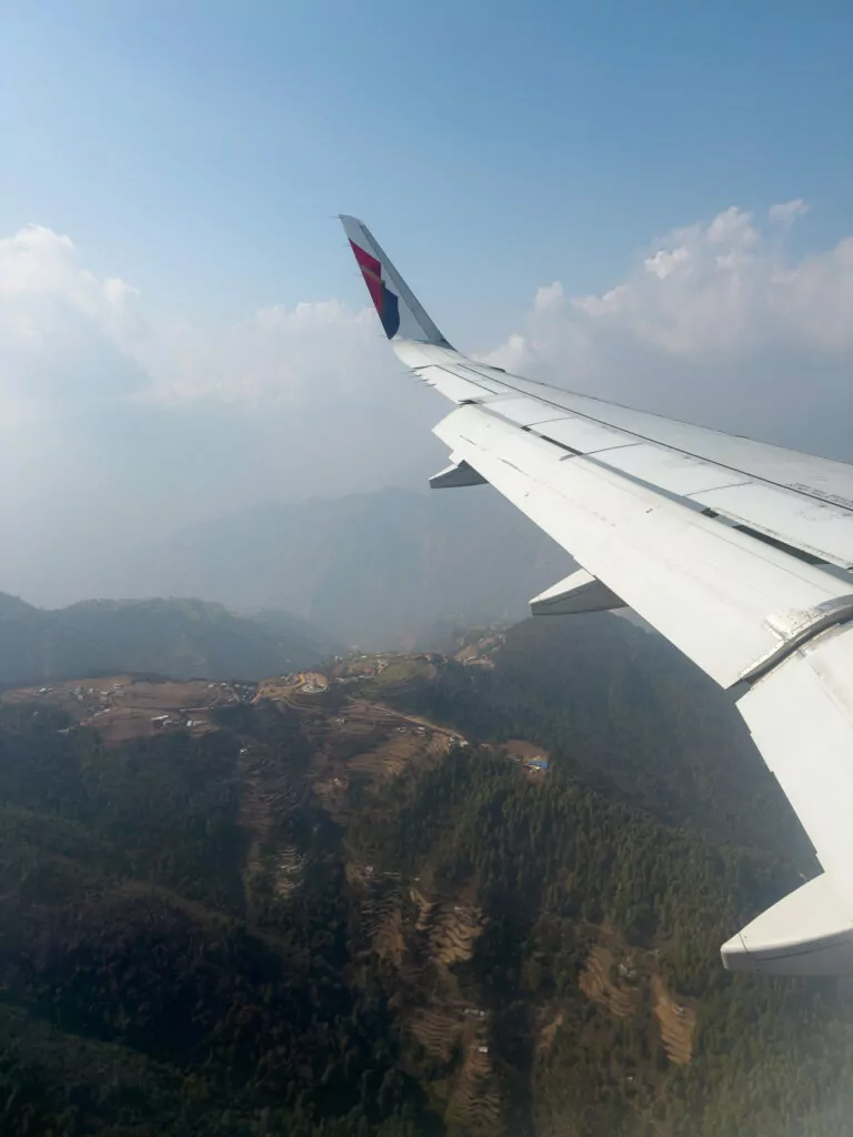 View of the Himalayan foothills from a plane window landing into Kathmandu
