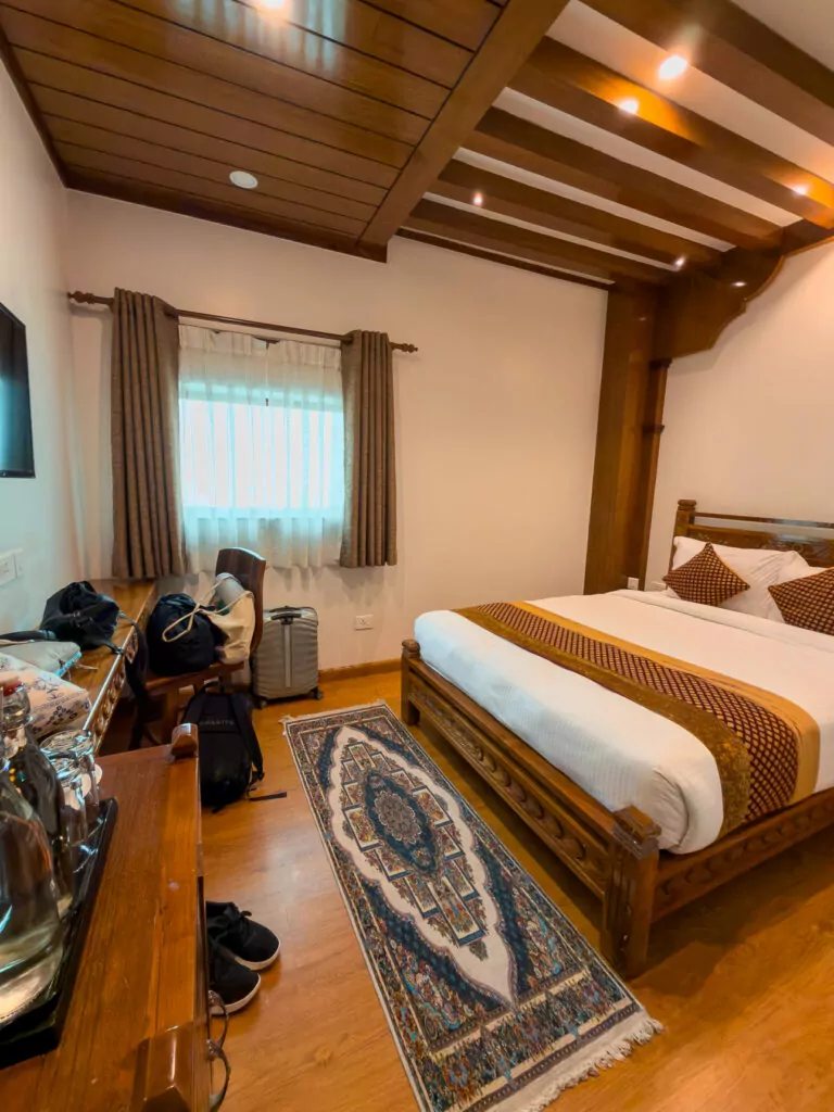 Twin beds with traditional patterned rugs in a room at the Surya Heritage Hotel in Kathmandu