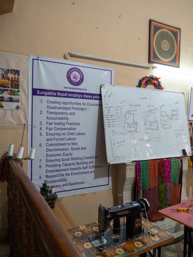 Whiteboard and information display in the community room at Sungabha Seven Sisters women's organisation in Kathmandu