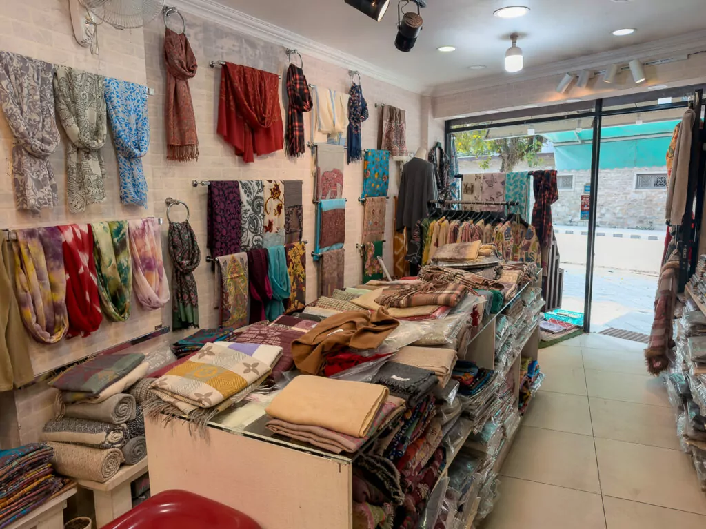 Colourful scarves, pashminas and textiles displayed in a cashmere shop in Pokhara