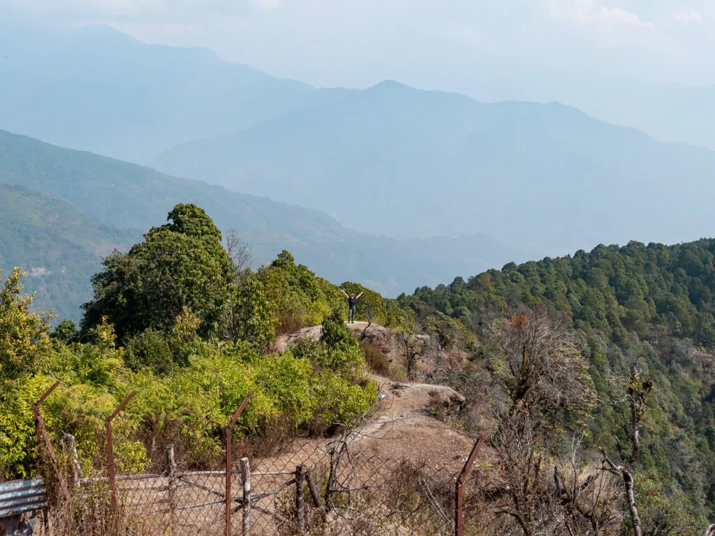 Small hillside village along the Australian Camp trekking route with mountains behind