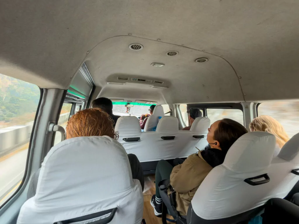 Travellers seated inside the One Life Adventures tour bus during a drive through Nepal