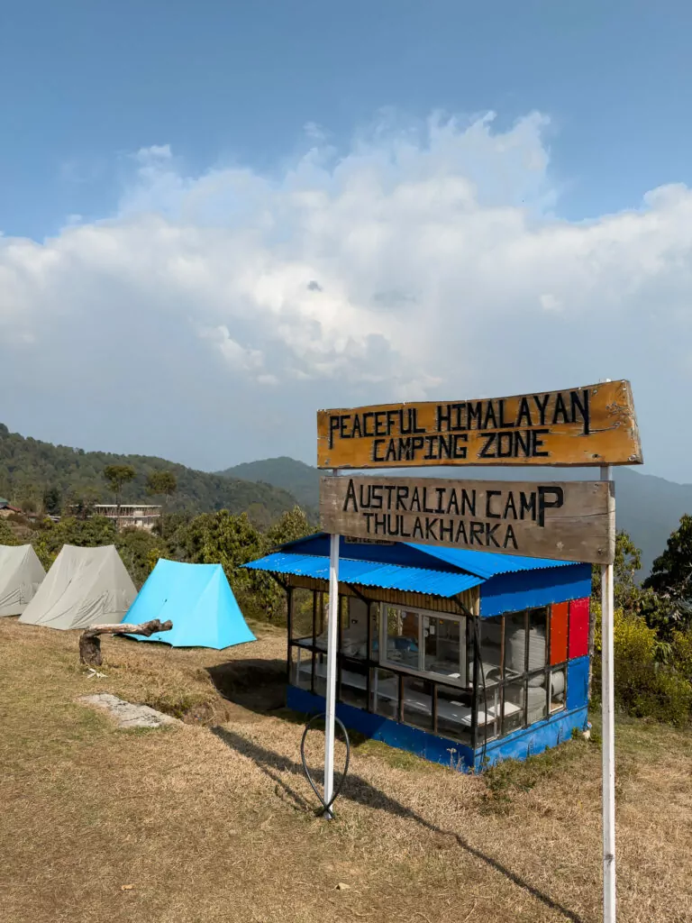 Sign for Australian Camp at the Peaceful Himalayan Camping Zone with a blue-roofed shelter