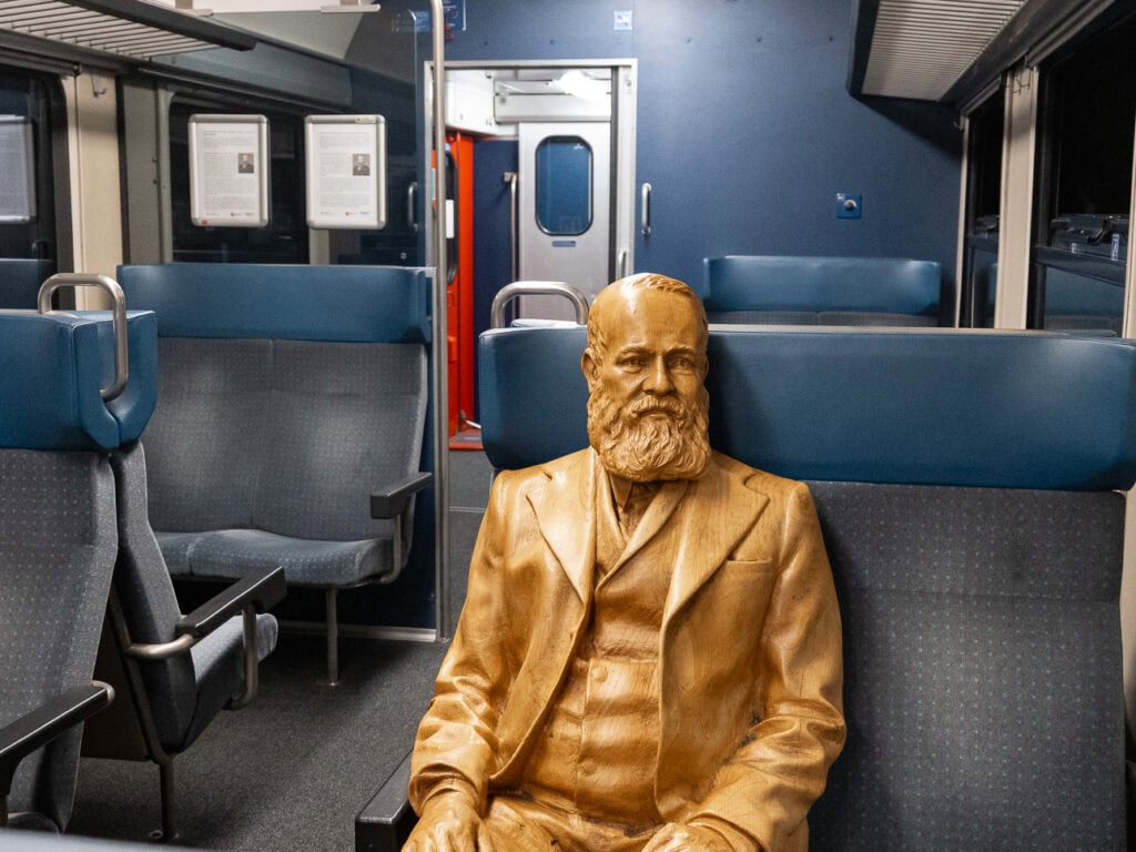 A golden bust of Alfred Escher, the 19th century Swiss entrepreneur behind the Gotthard Railway, displayed in the photo coach