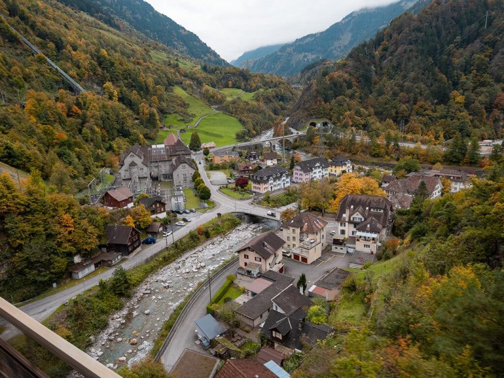 The village of Amsteg tucked into the Reuss valley, seen from the Gotthard Panorama Express train