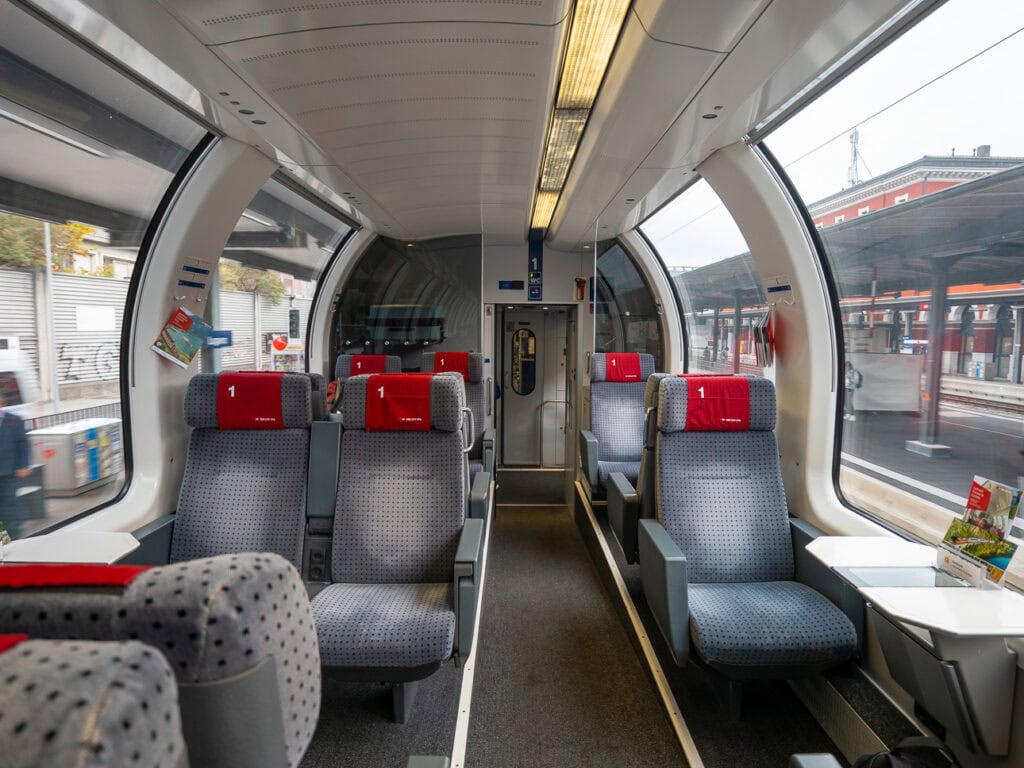 Inside a 1st class Gotthard Panorama Express carriage with curved panoramic windows