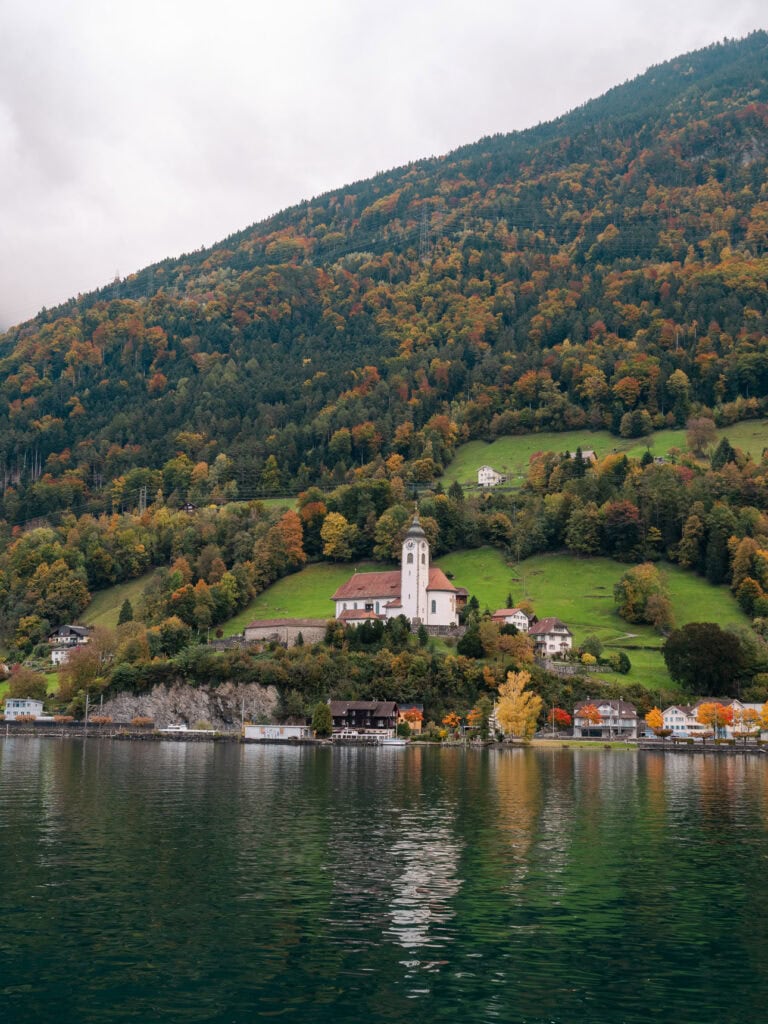 Flüelen village and its lakeside church seen from the water