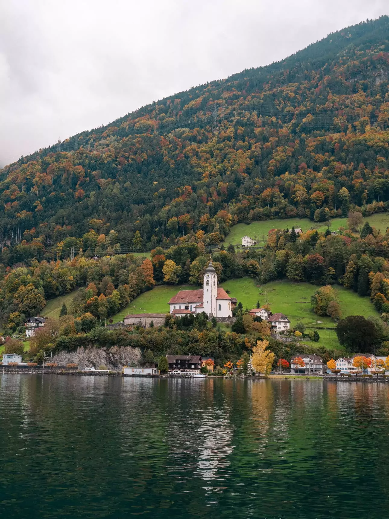 Flüelen village and its lakeside church seen from the water