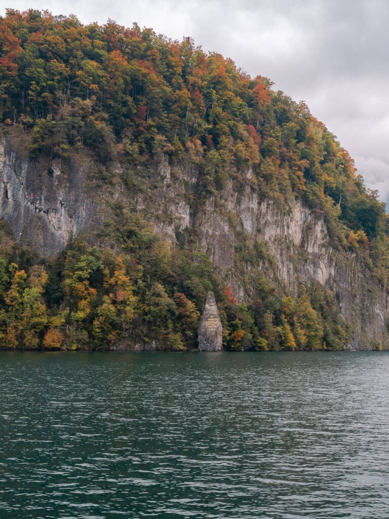 The Schillerstein natural rock obelisk rising from Lake Lucerne, dedicated to William Tell author Friedrich Schiller