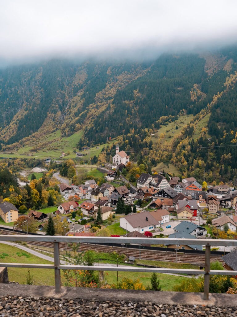 The hilltop Wassen church surrounded by autumn-coloured hillsides in central Switzerland