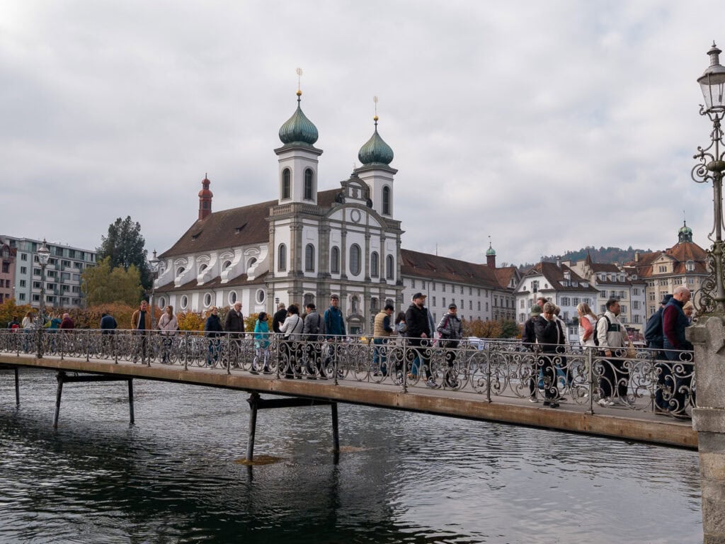 Lucerne's iconic Jesuit Church with its twin onion-domed towers, seen across the river from the Chapel Bridge area