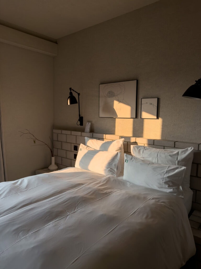 A plush bed with crisp linens in a minimalist room at B5 Boutique Hotel in Lugano