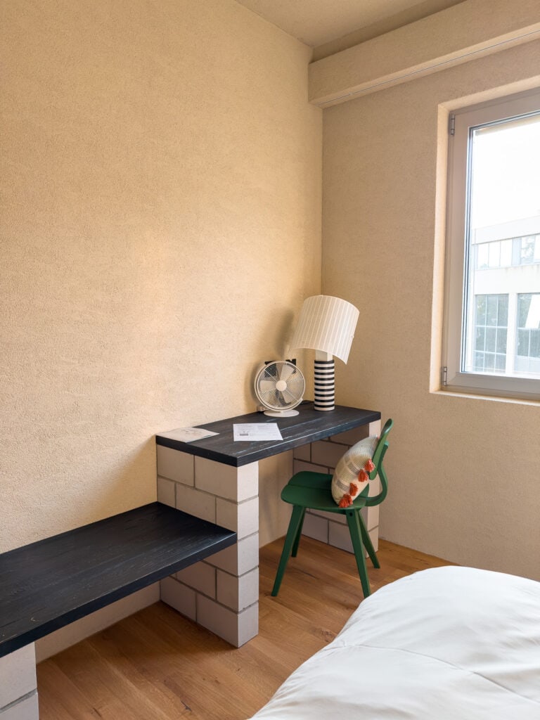 A minimalist-chic room at B5 Boutique Hotel in Lugano with a proper work desk by a bright window