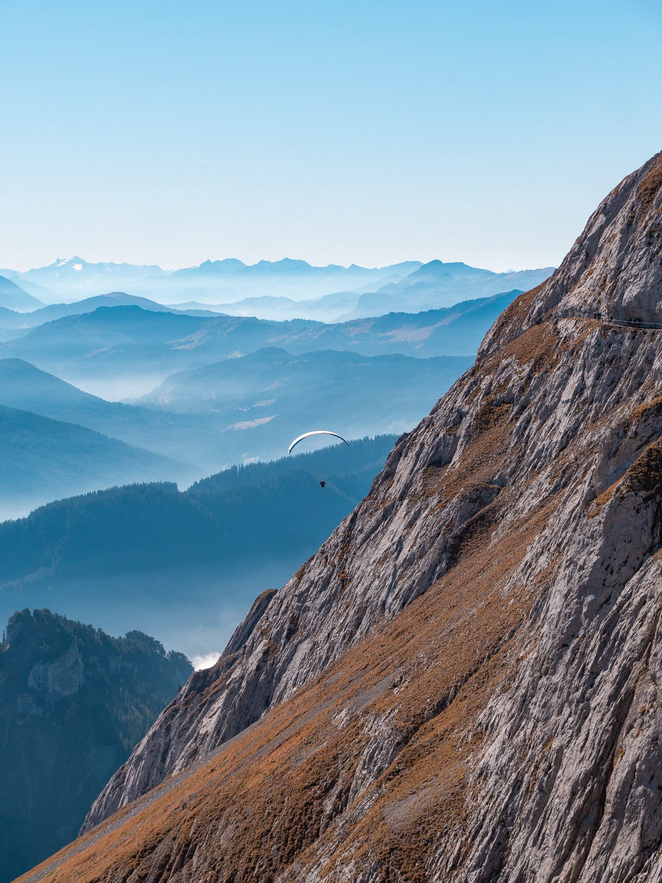 Paraglider flying beside Mount Pilatus in Switzerland
