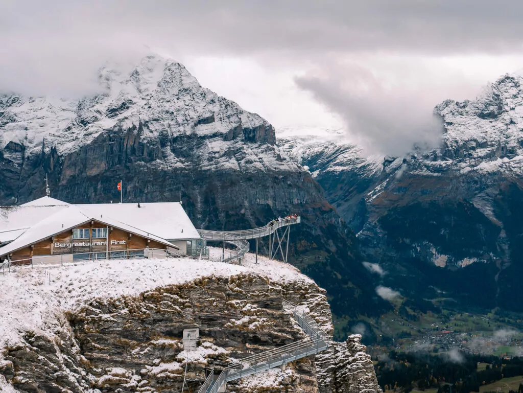 Grindelwald First cliff walk and mountain restaurant with snowy peaks in the Bernese Oberland, Switzerland