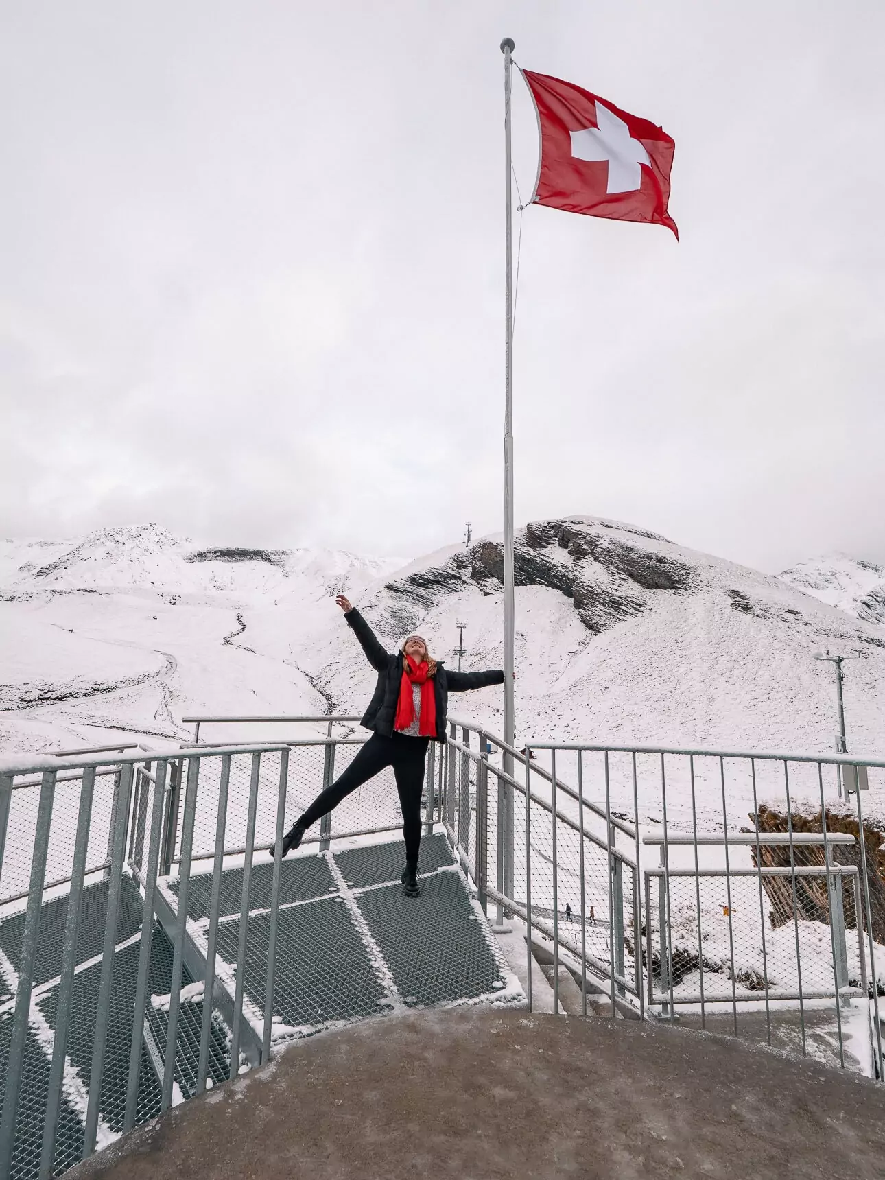 Swiss flag on a snowy viewing platform at Grindelwald First
