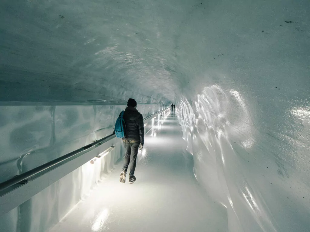 Visitor walking through the Ice Palace tunnel at Jungfraujoch