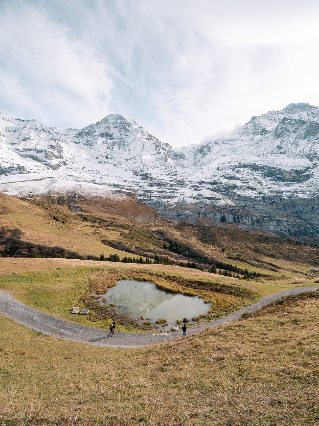 Snow covered Eiger, Mönch and Jungfrau mountains above an alpine lake near Kleine Scheidegg