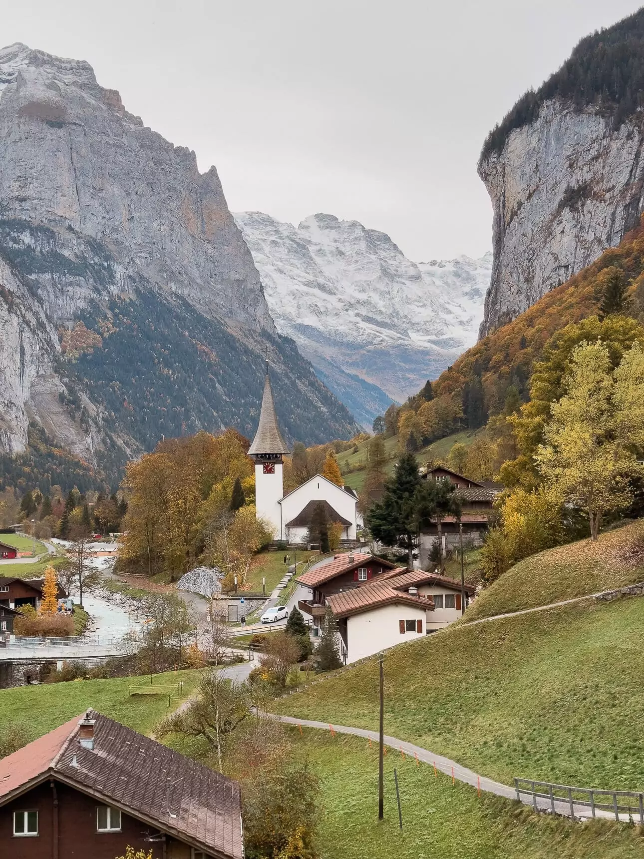Lauterbrunnen village church framed by cliffs and snowy mountains in Switzerland