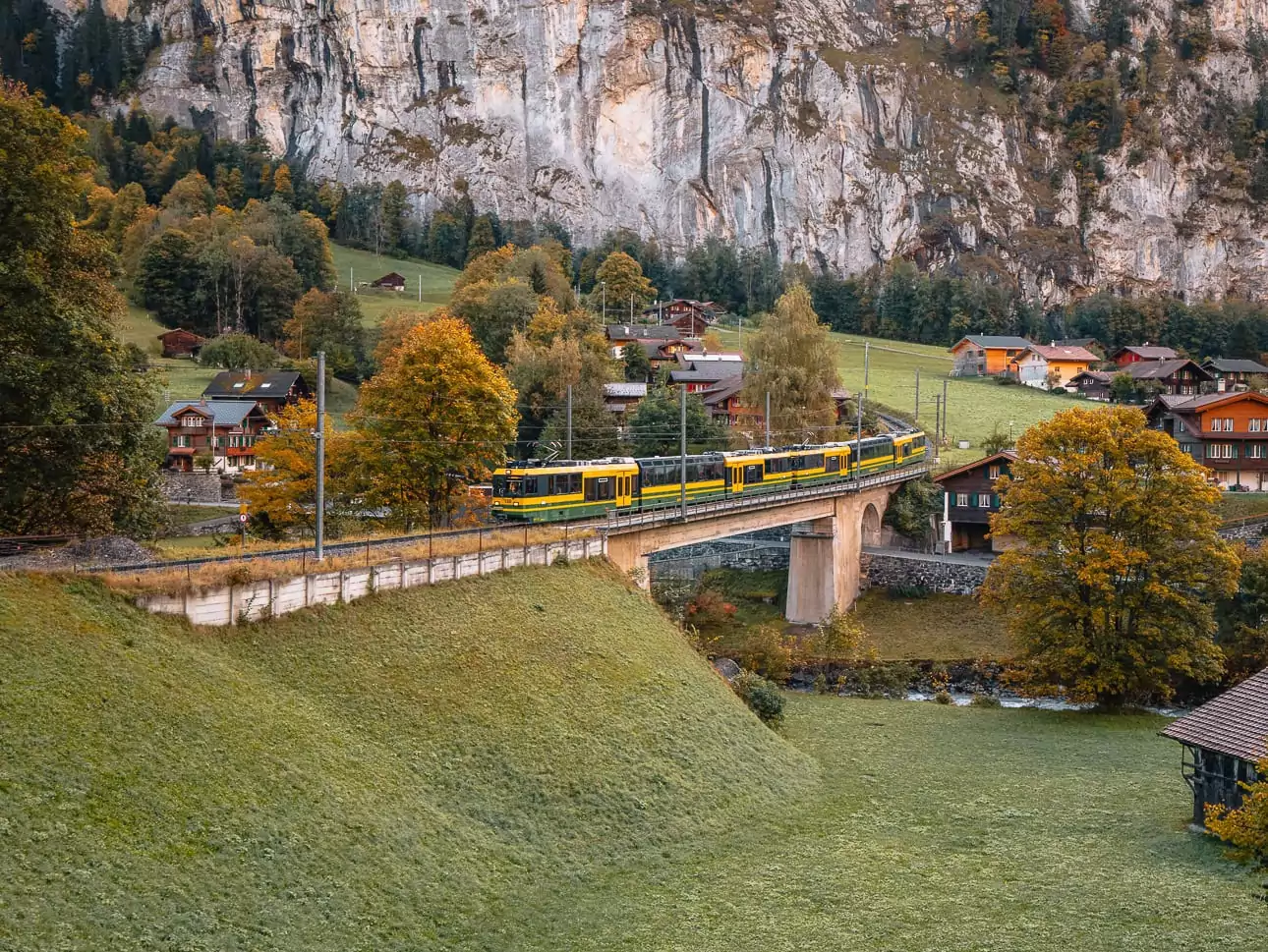 Wengernalp Railway emoji train crossing a bridge in Lauterbrunnen, Bernese Oberland