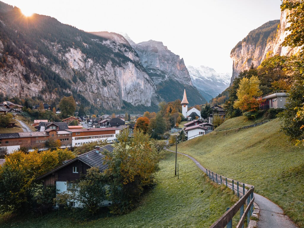 Lauterbrunnen village and church surrounded by cliffs and autumn colours