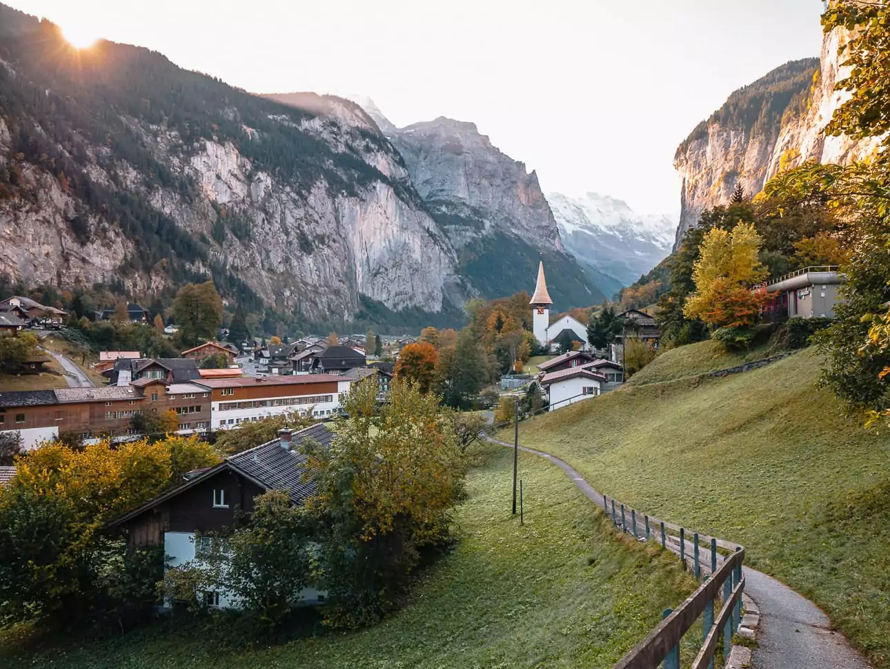 Lauterbrunnen village and church surrounded by cliffs and autumn colours