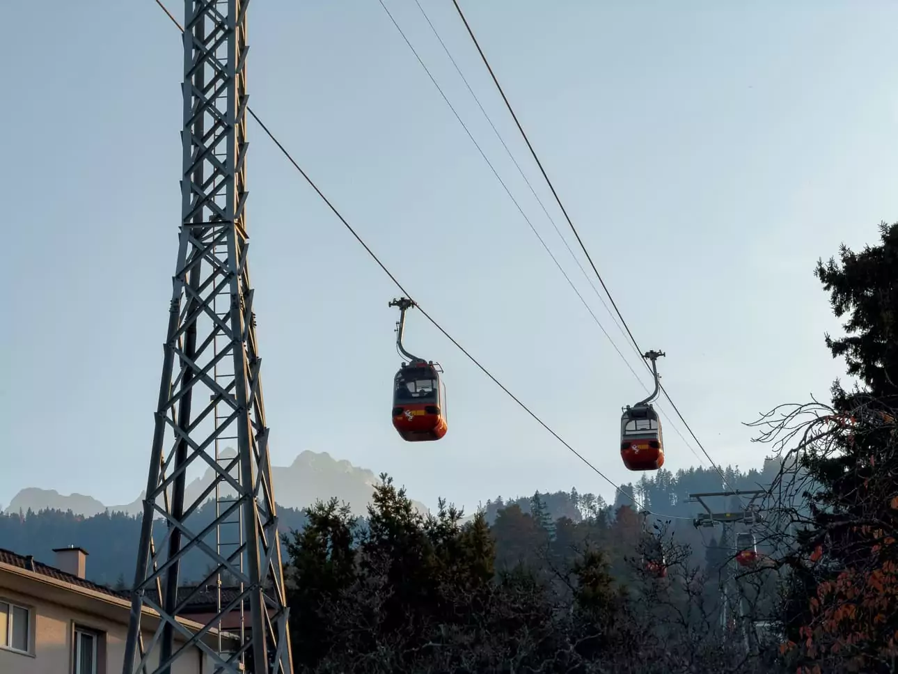 Mount Pilatus cable cars travelling above trees near Lucerne