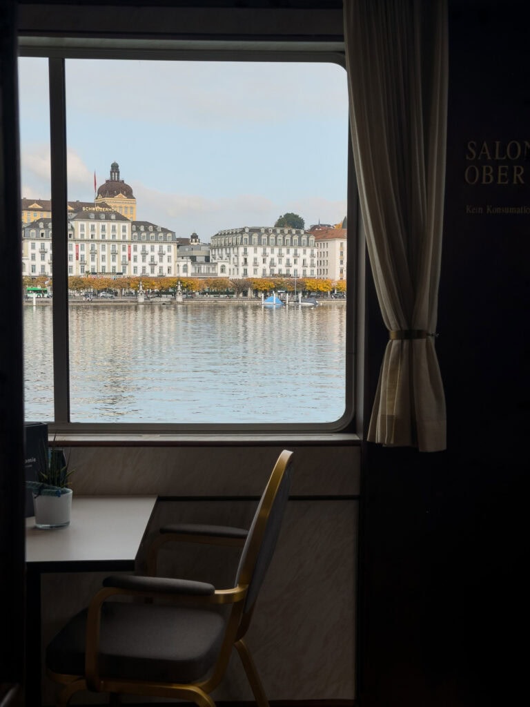 Lake Lucerne view from inside a boat, looking towards the Schweizerhof hotel