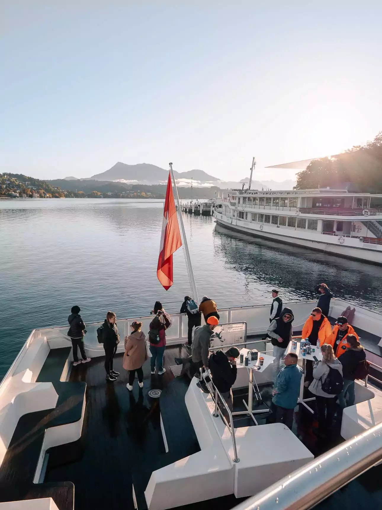 Lake Lucerne cruise boat with passengers on deck and mountains in the distance