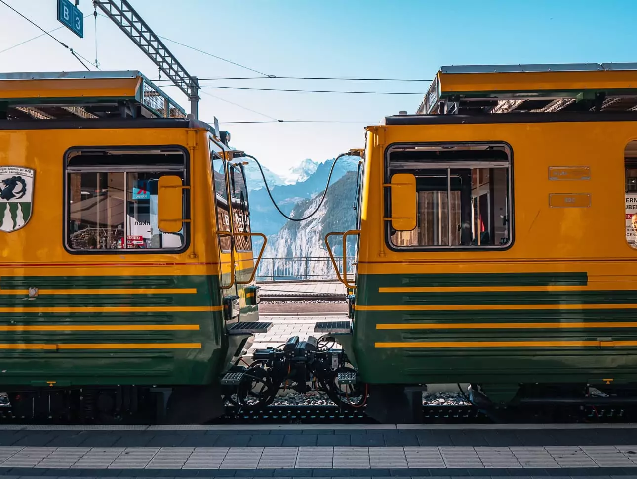 Yellow and green train at Wengen station in the Jungfrau region