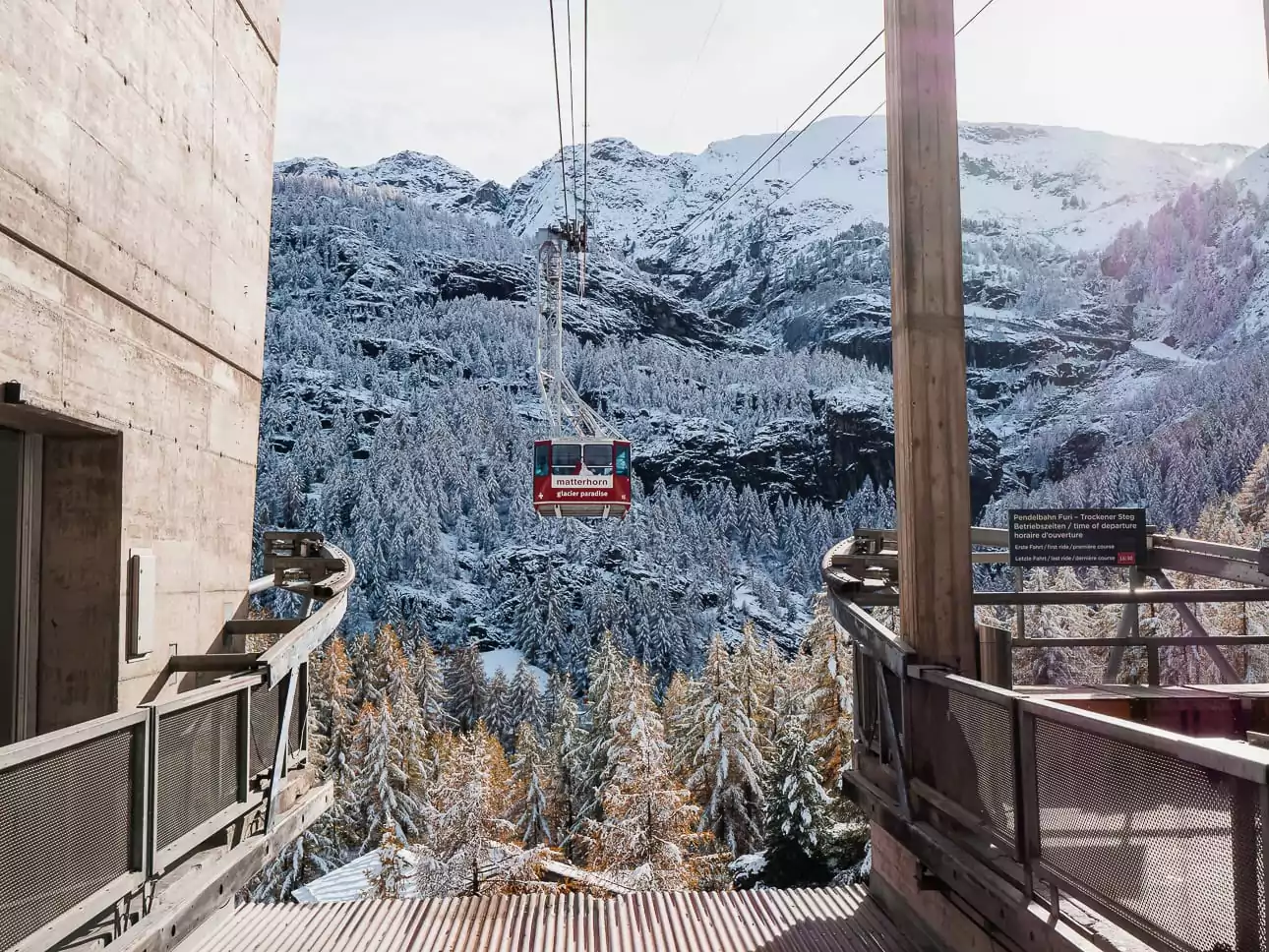 Matterhorn Glacier Paradise cable car travelling above snowy forest near Zermatt