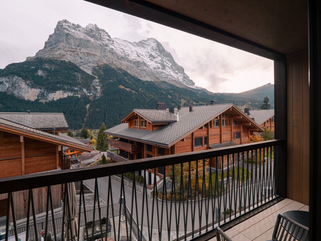 View from a Bergwelt Grindelwald balcony looking across to traditional chalets and snow-covered mountains