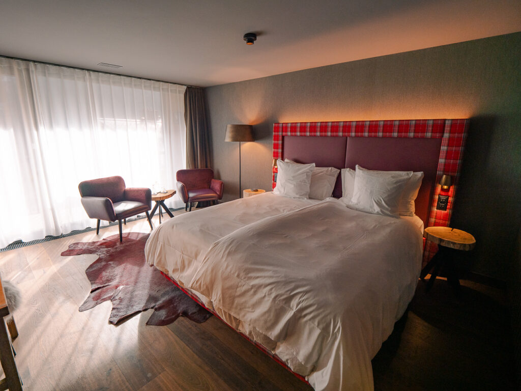 Bergwelt Grindelwald bedroom with the bed facing a large window looking out at the Eiger and surrounding peaks