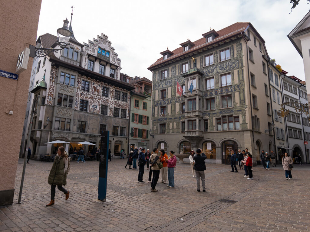 Frescoed guild houses around a cobbled square in Lucerne's Altstadt old town