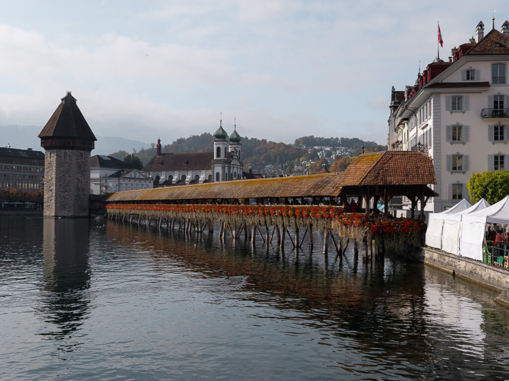 The Kapellbrücke covered wooden bridge and its stone water tower on the river Reuss in Lucerne