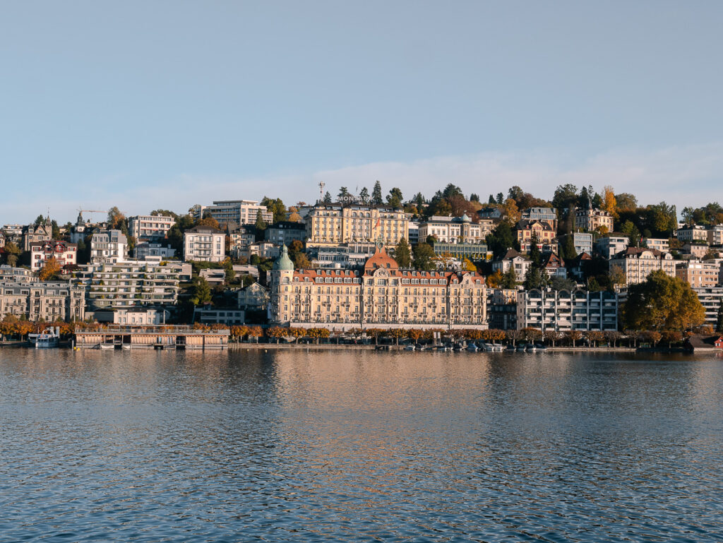 The Mandarin Oriental Palace on the Lucerne lakefront seen from across the water in golden light
